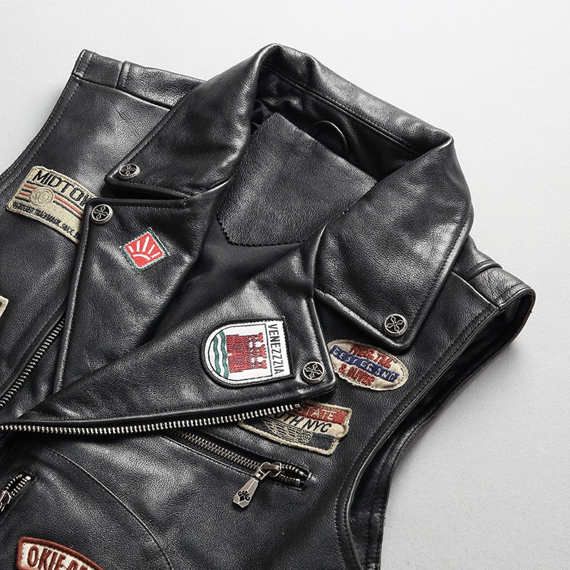 Men's cowhide leather biker vest with patches and zippers, perfect for a stylish rider look.