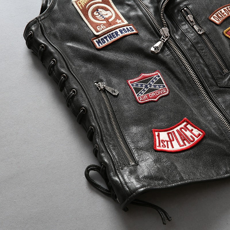 Men's cowhide leather biker vest featuring patches and zippers, perfect for stylish riders on the road.