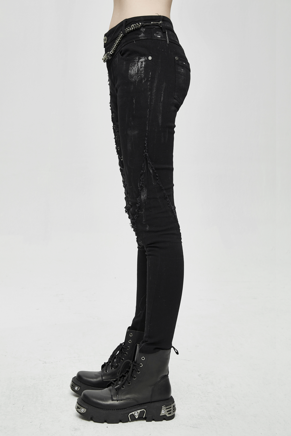 Unique women's steampunk skinny jeans in black with stylish lacing and distressed design, paired with edgy black boots.
