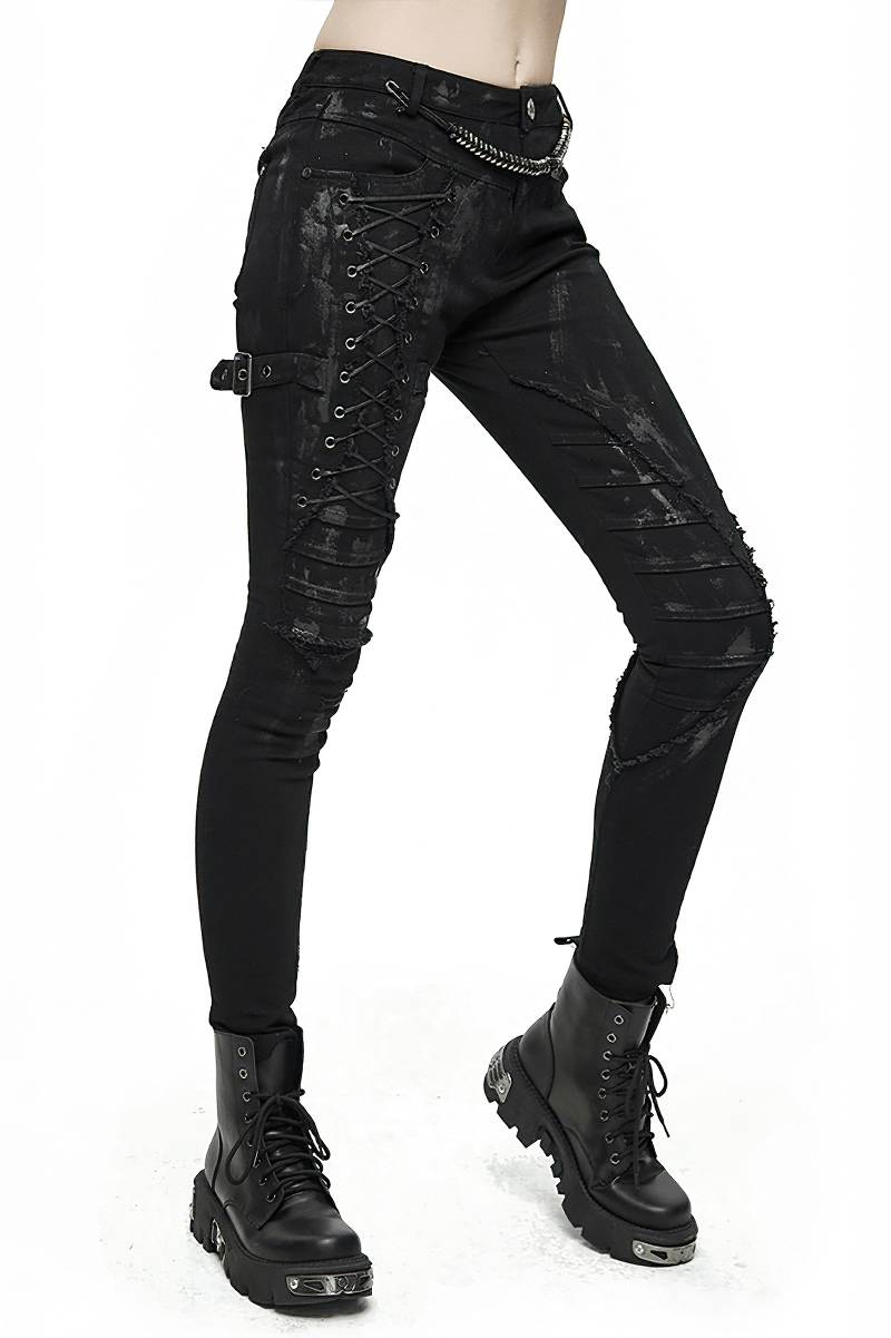Black steampunk skinny jeans with lacing detail, paired with edgy black boots for alternative streetwear style.
