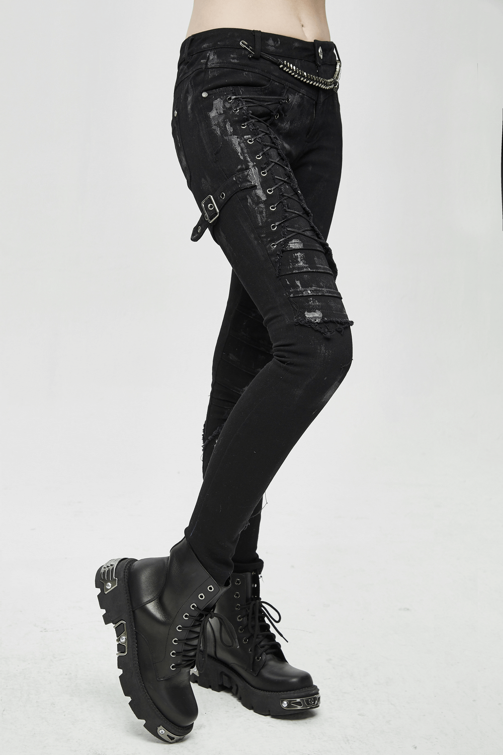 Unique women's steampunk skinny black jeans with lacing detail, paired with stylish black combat boots.
