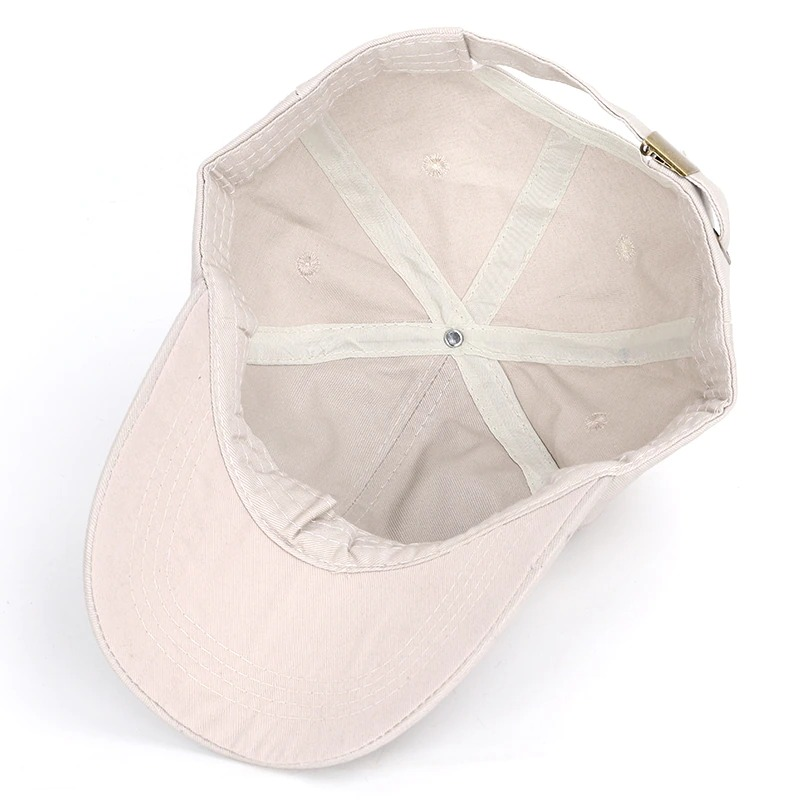 Inside view of a unisex baseball cap with a skull print, showcasing the soft cotton lining and adjustable strap.