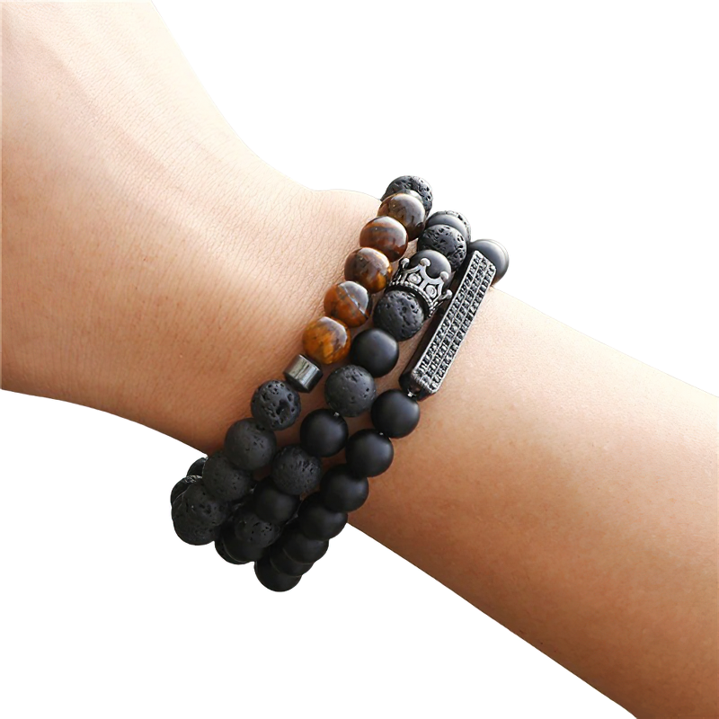 Unisex black matte onyx stone bracelet stacked on wrist, featuring vintage beads and stylish crown design.