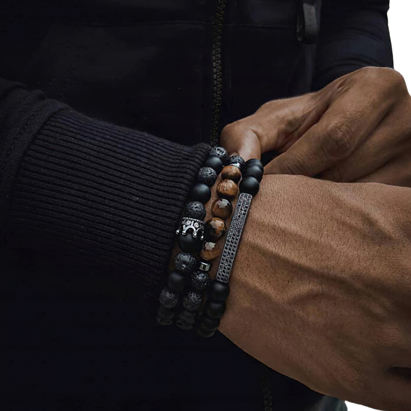 Close-up of unisex black matte onyx stone bracelet on a wrist, showcasing stylish vintage design with multiple beaded layers.