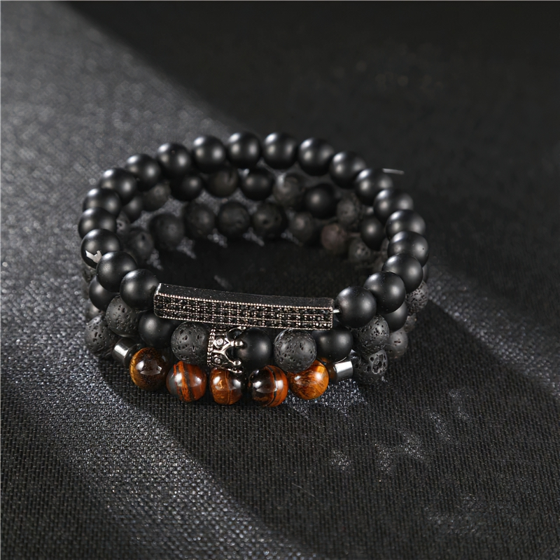 Unisex black matte onyx stone bracelet with varied bead textures and vintage crown design, perfect alternative accessory.