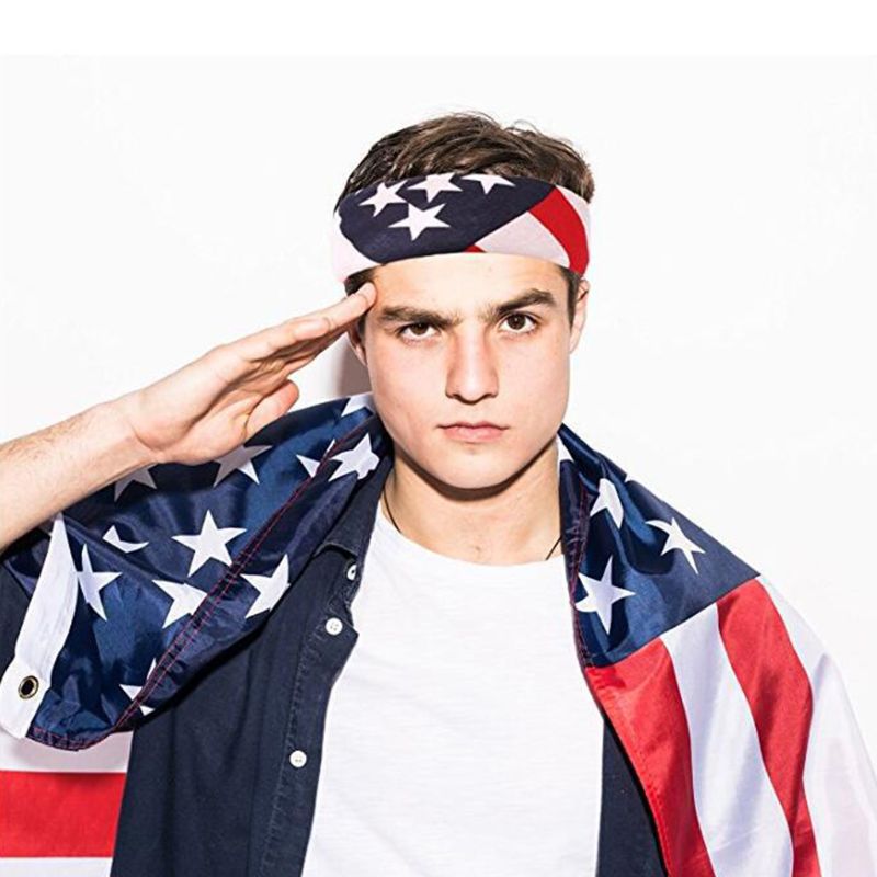 Young man saluting while wearing an American flag bandana and cape, perfect for patriotic celebrations and team support.