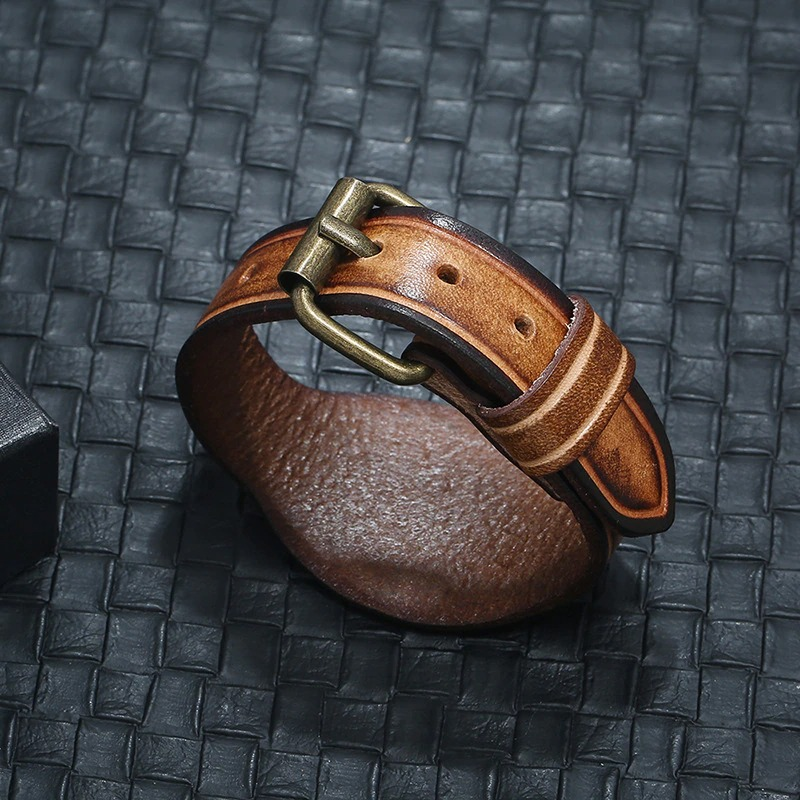 Unisex vintage brown genuine leather bracelet with wide bangle style and bold buckle detail.