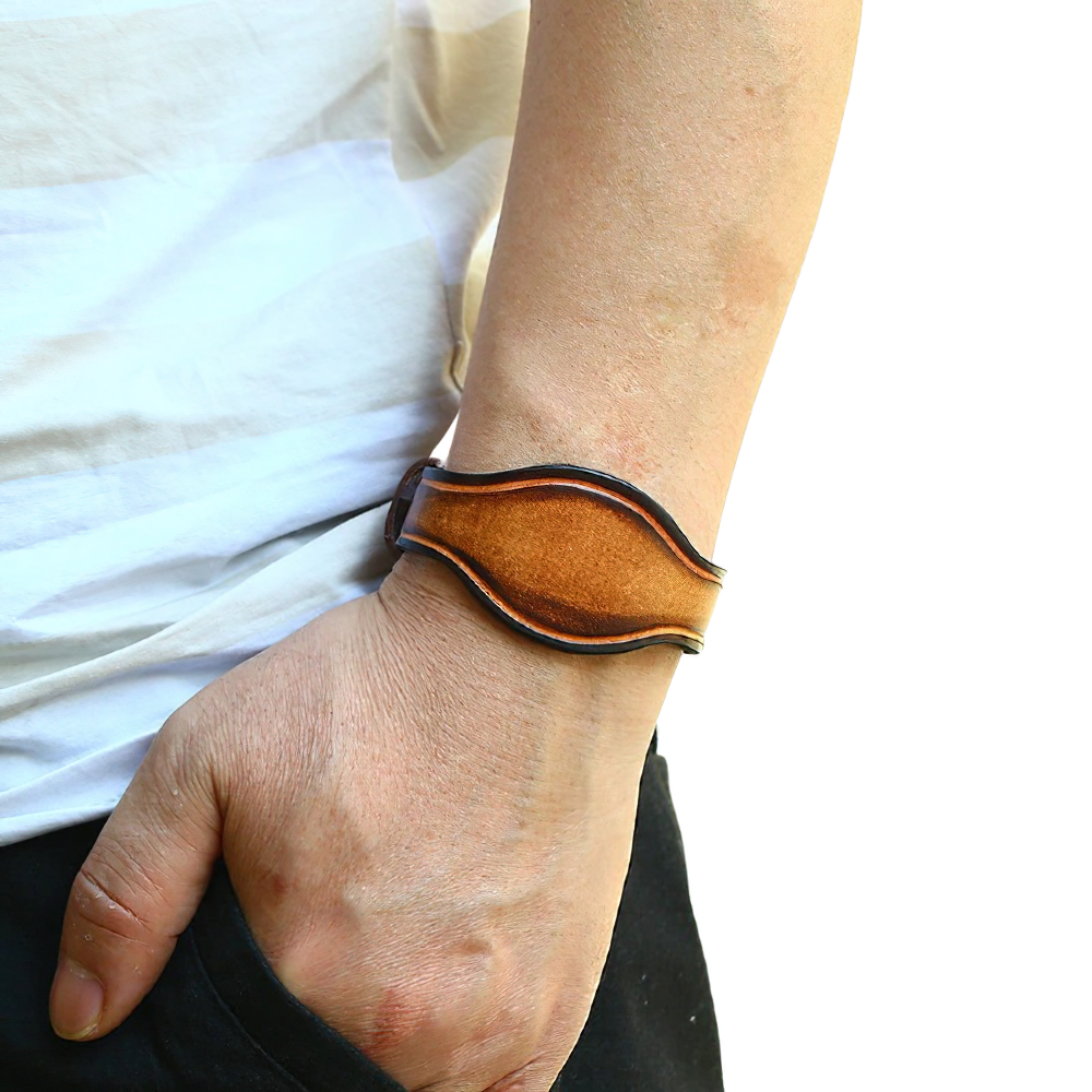 Unisex brown genuine leather bracelet shown on wrist, wide vintage punk style accessory for men and women.