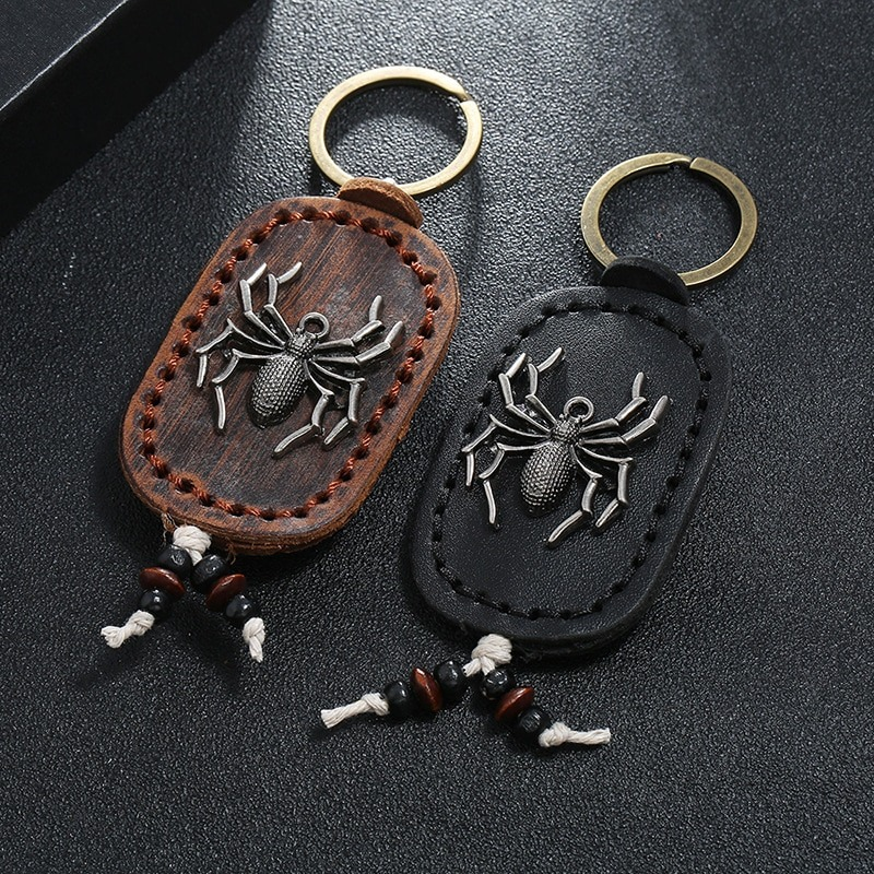 Vintage unisex leather keychain featuring a spider pendant in zinc alloy, available in brown and black.