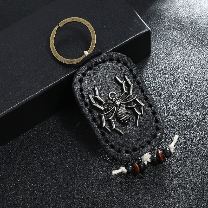 Unisex handmade leather keychain featuring a vintage spider pendant, perfect for stylish bag decoration.