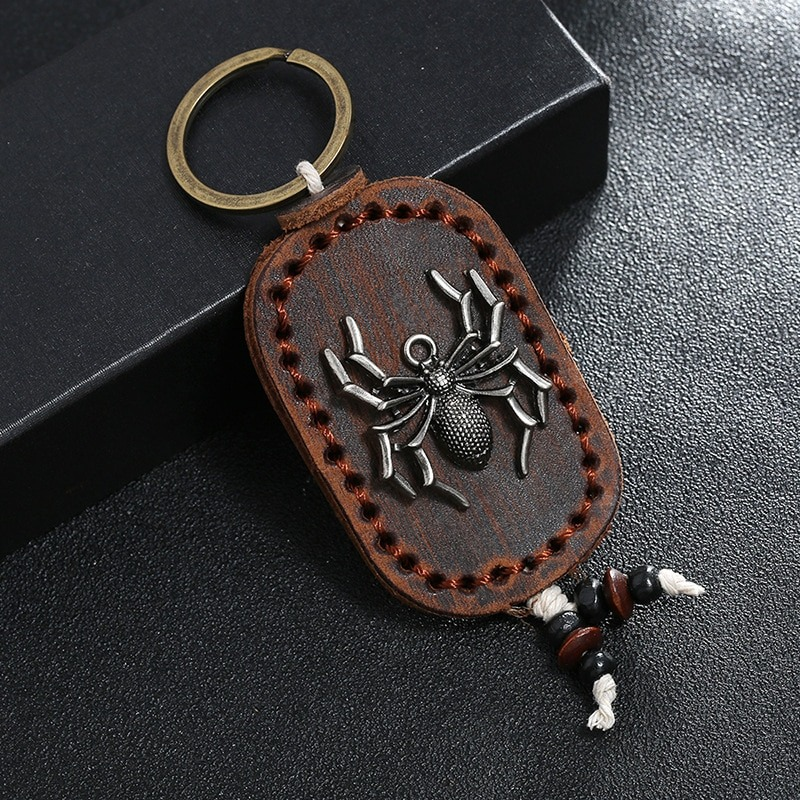Vintage unisex leather keychain with spider zinc alloy pendant, perfect for gifts and bag accessories.