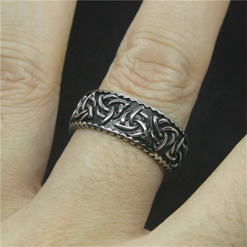 Unisex stainless steel Gothic ring with intricate Viking symbols on a finger, perfect for cosplay and rock outfits.