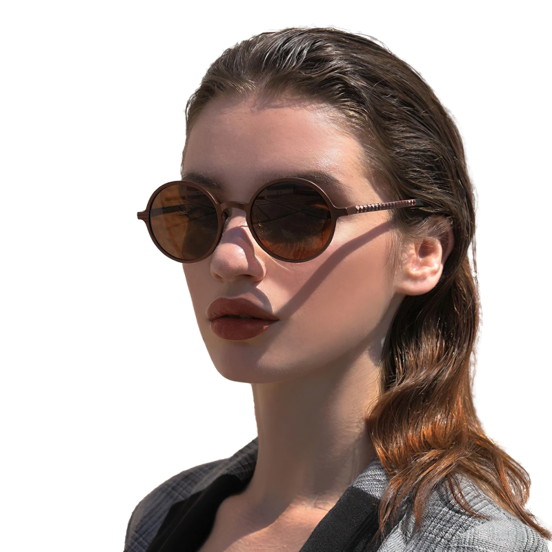 Unisex luxury round sunglasses featuring a vintage style on a model with wavy hair, perfect for casual accessories.