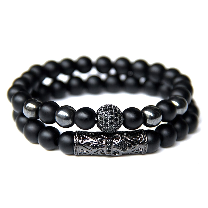 Unisex natural beaded bracelet featuring matte black beads and vintage-style charm for alternative fashion.