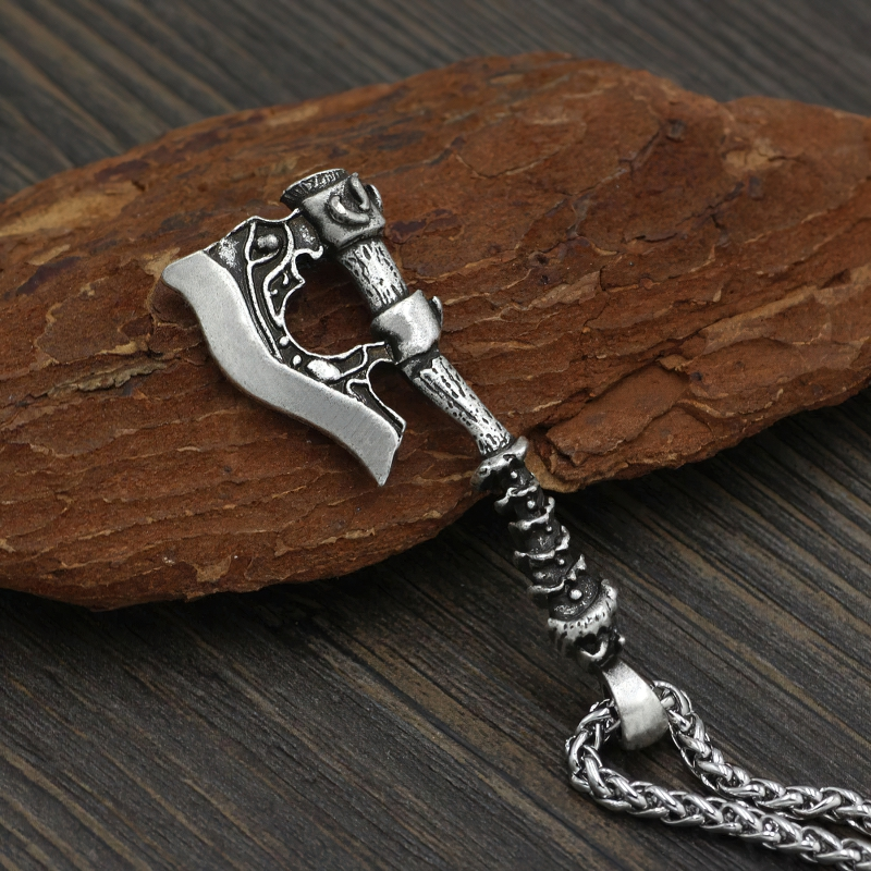 Stylish unisex Viking axe pendant on wood background, a unique casual necklace accessory in silver tone.