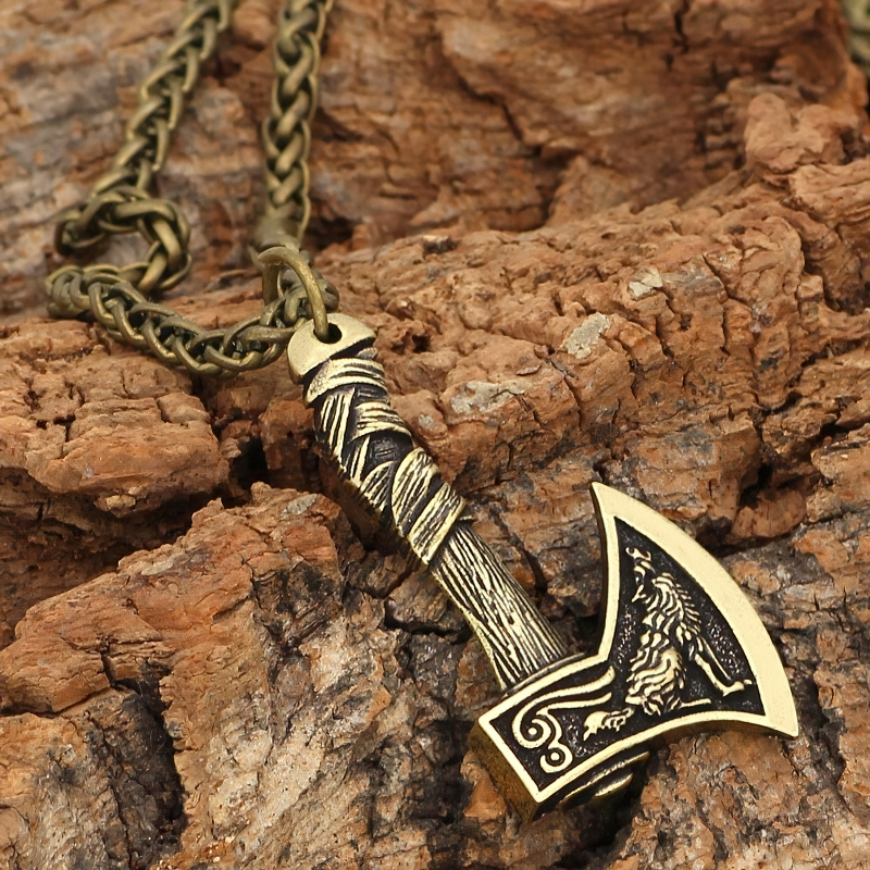 Unisex Viking axe pendant necklace on a wooden background, featuring intricate wolf design, stylish casual accessory.