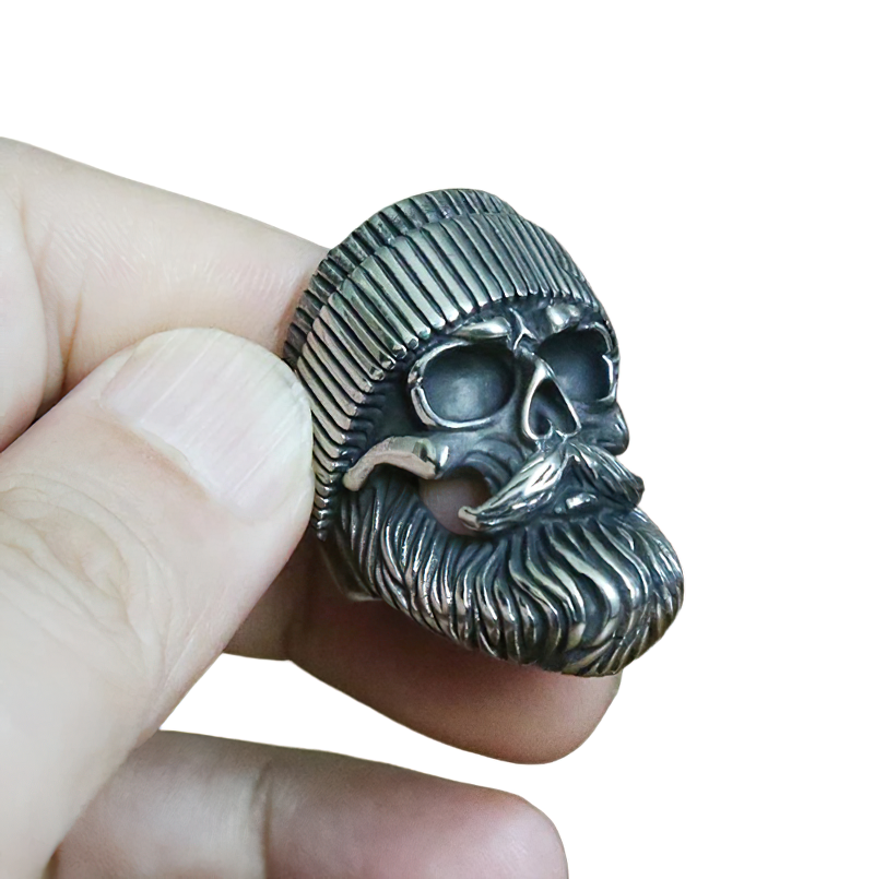 Unisex skull ring with beard and hat held in hand, stylish biker jewelry made of stainless steel.