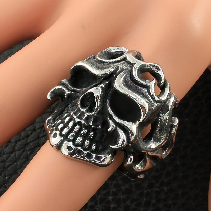 Unisex stainless steel gothic ring shaped like a skull, perfect for punk and rock styles on a hand model.