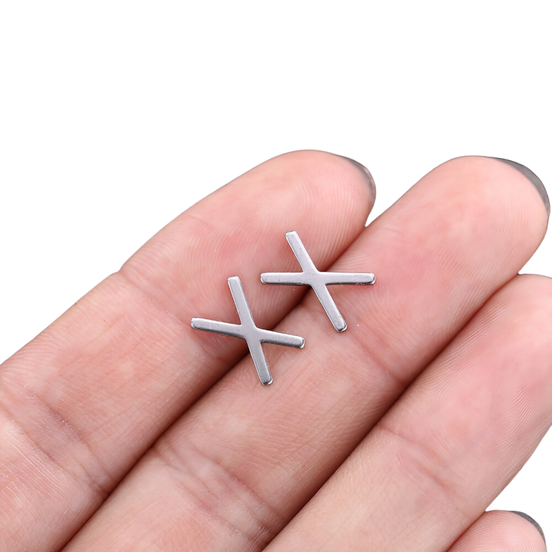 Unisex stainless steel vintage silver earrings held in a hand, showcasing a gothic style design.