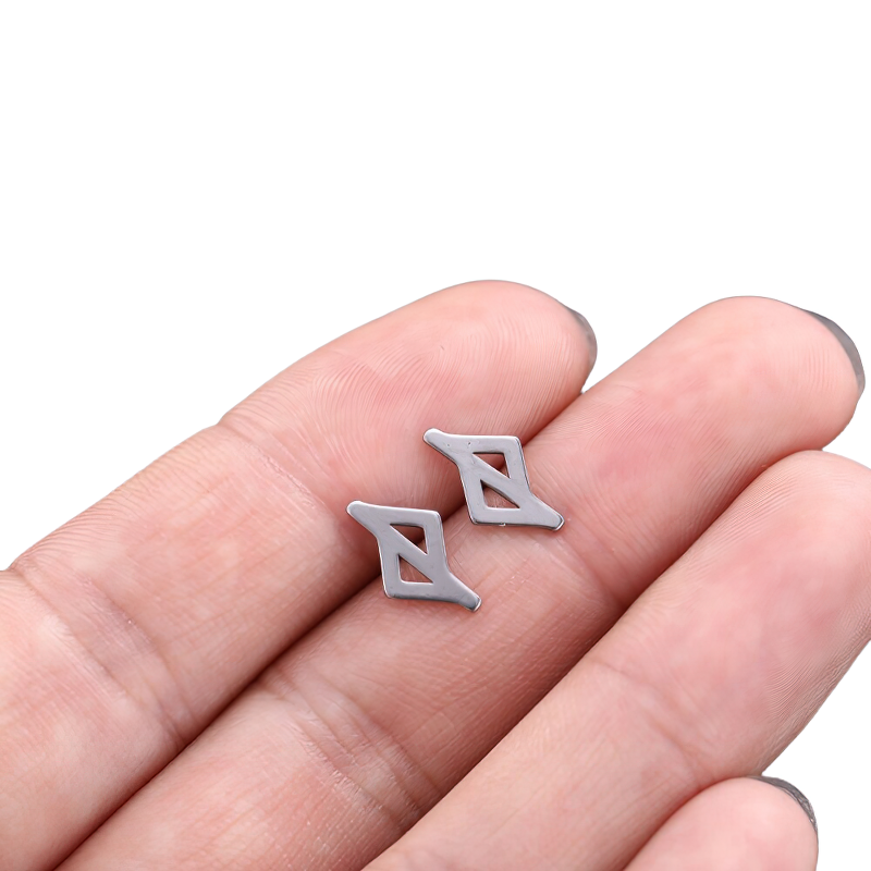 Unisex vintage silver earrings displayed on a hand, showcasing their stylish Gothic design in quality stainless steel.