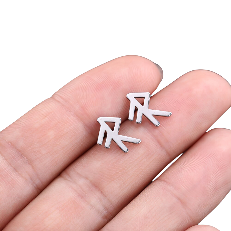 Unisex vintage silver stainless steel earrings in a gothic style, displayed on a hand, perfect for any outfit.