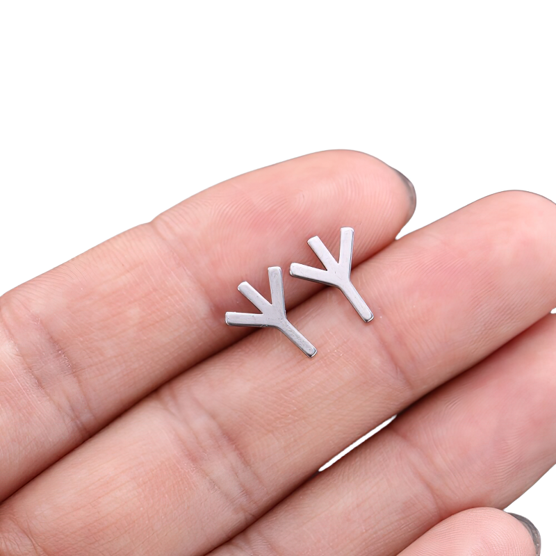 Unisex vintage silver stainless steel earrings in a unique gothic style, held in a hand.