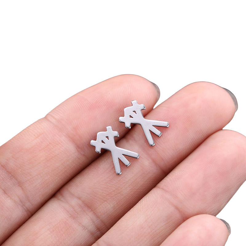 Unisex vintage gothic stainless steel earrings held in hand, stylish and modern design for any outfit.