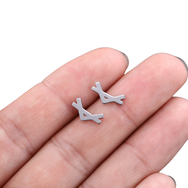 Unisex vintage silver earrings made of stainless steel, showcasing a unique Gothic design held in a hand.