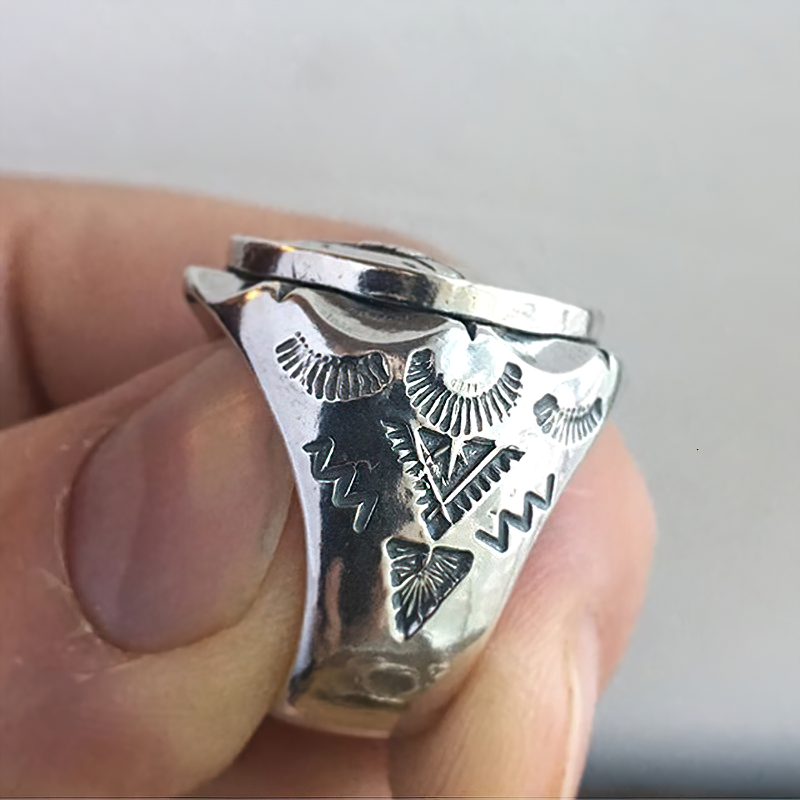 Close-up of unisex stainless steel biker ring with intricate designs, showcasing its shiny silver finish.