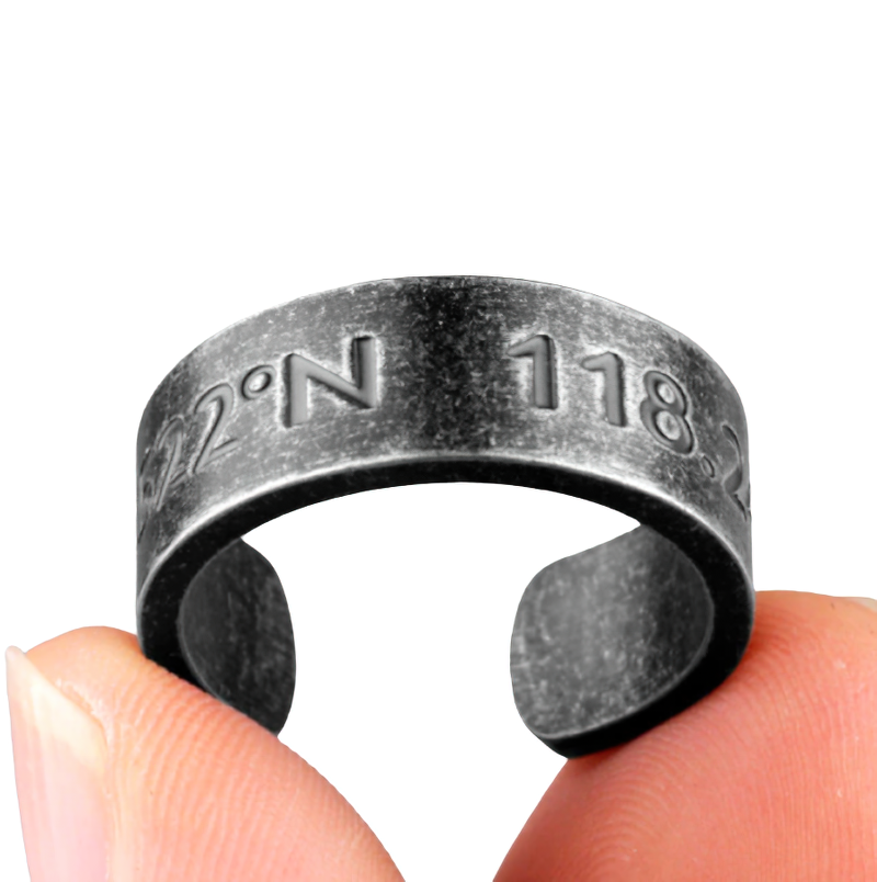 Unisex stainless steel ring with unique inscription held between fingers, stylish casual jewelry for everyday wear.