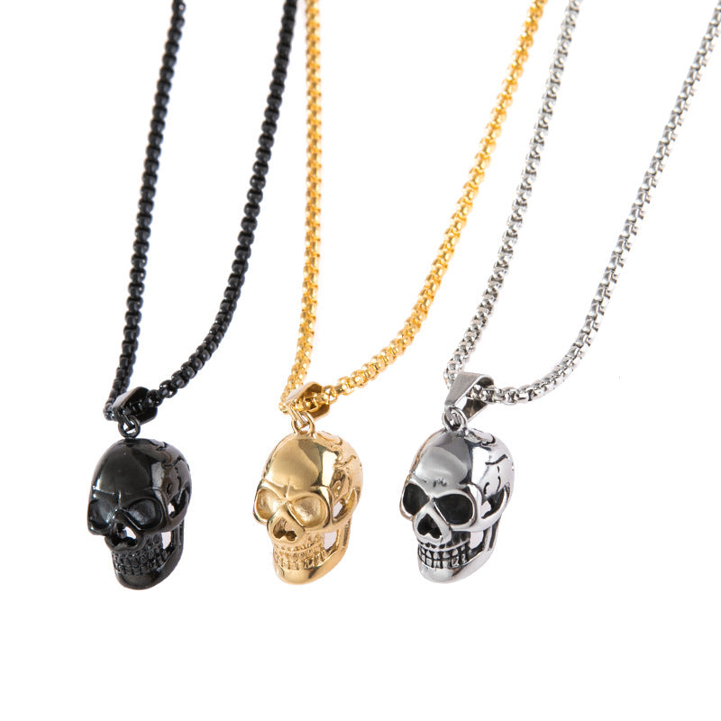 Unisex stainless steel skull necklaces in black, gold, and silver on display for stylish rock accessory lovers.