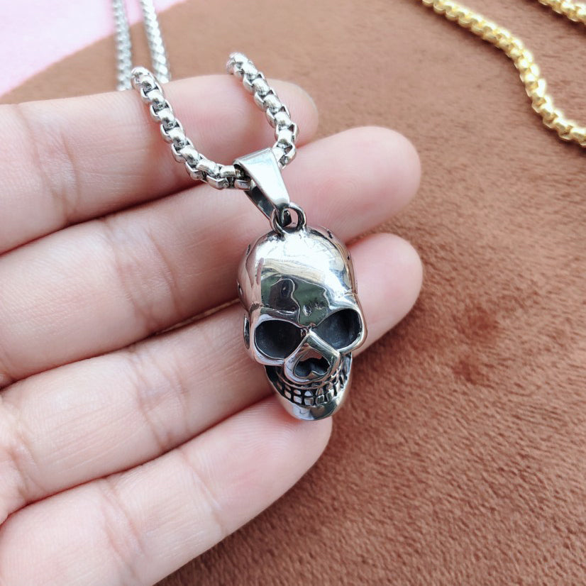 Unisex stainless steel skull pendant necklace on a chain, perfect for biker rock style accessories.
