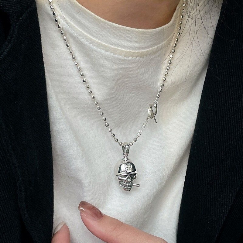 Unisex sterling silver skeleton pendant on a silver chain, showcasing a vintage punk skull style, perfect for alternative jewelry lovers.