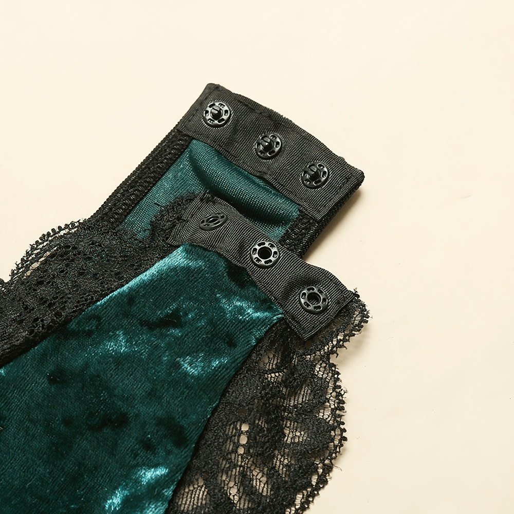 Close-up of green velvet bodysuit with black lace and decorative buttons for an elegant look.