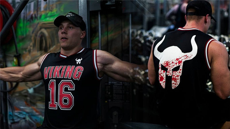 Man working out in a Viking tank top, showcasing cool horned helmet logo on the back, perfect for gym or fitness activities.