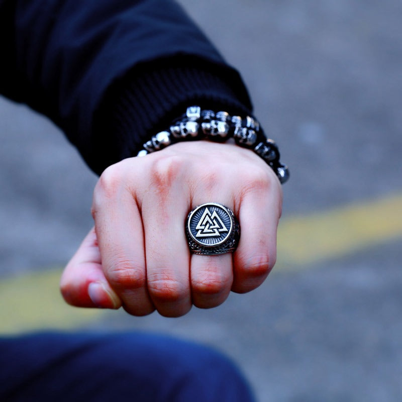 Viking stainless steel ring with Valknut design worn on a hand, paired with decorative bracelets.