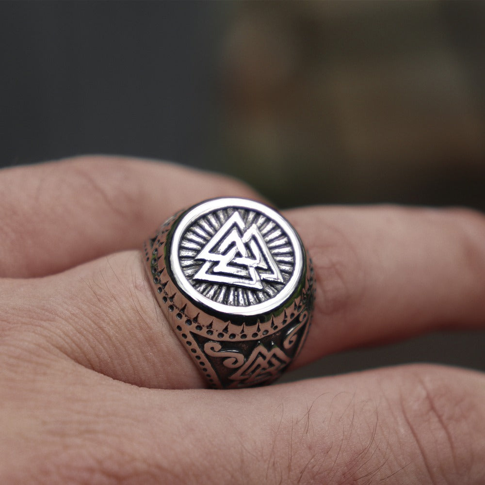 Close-up of Viking stainless steel ring with Valknut design on hand, showcasing Norse style and intricate details.