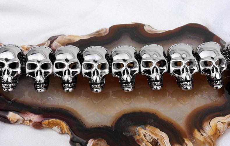 Vintage biker necklace featuring a row of shiny skulls on an agate background, perfect for rock and goth styles.