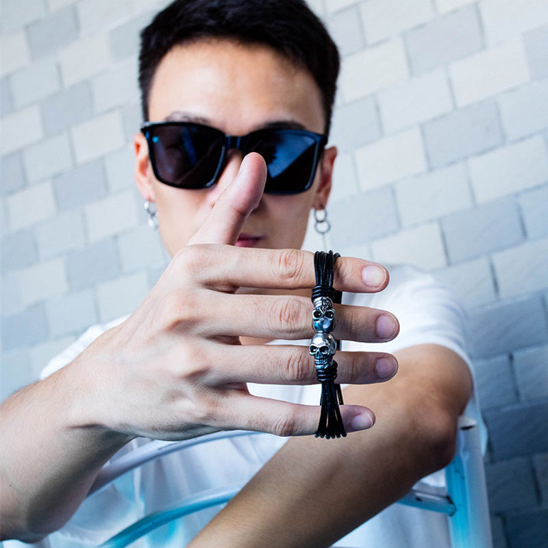 Unisex vintage black double skull bracelet showcased on a model with sunglasses, perfect for a rock-style look.