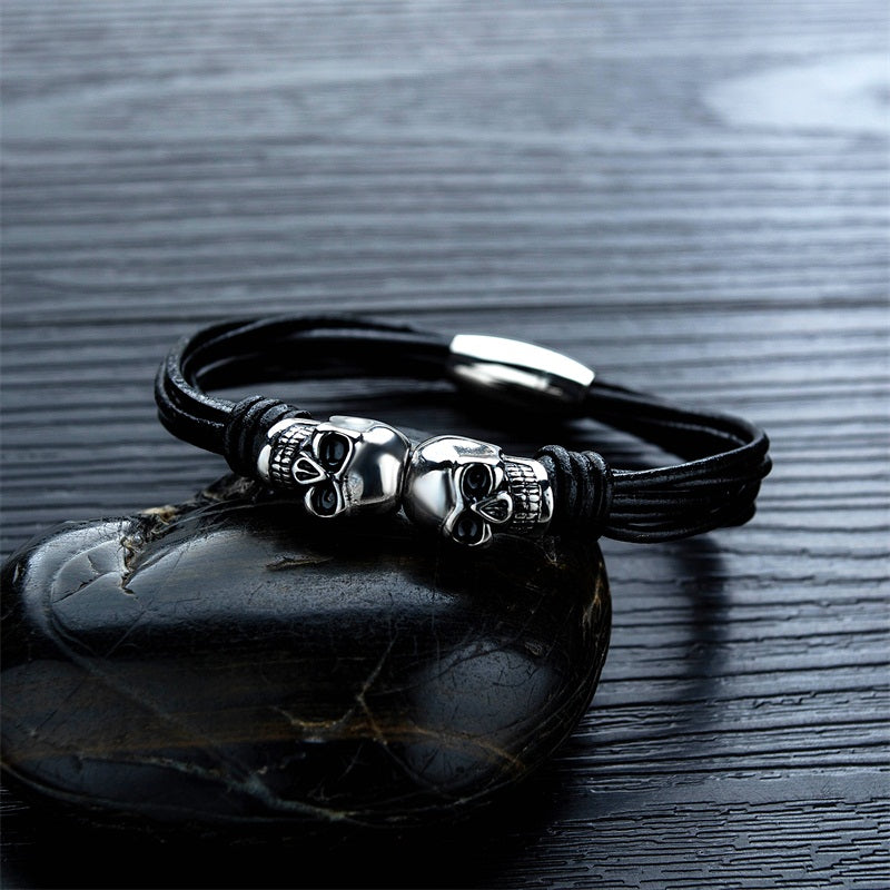 Unisex vintage black double skull bracelet with stainless steel accents, perfect for unique rock style accessories.