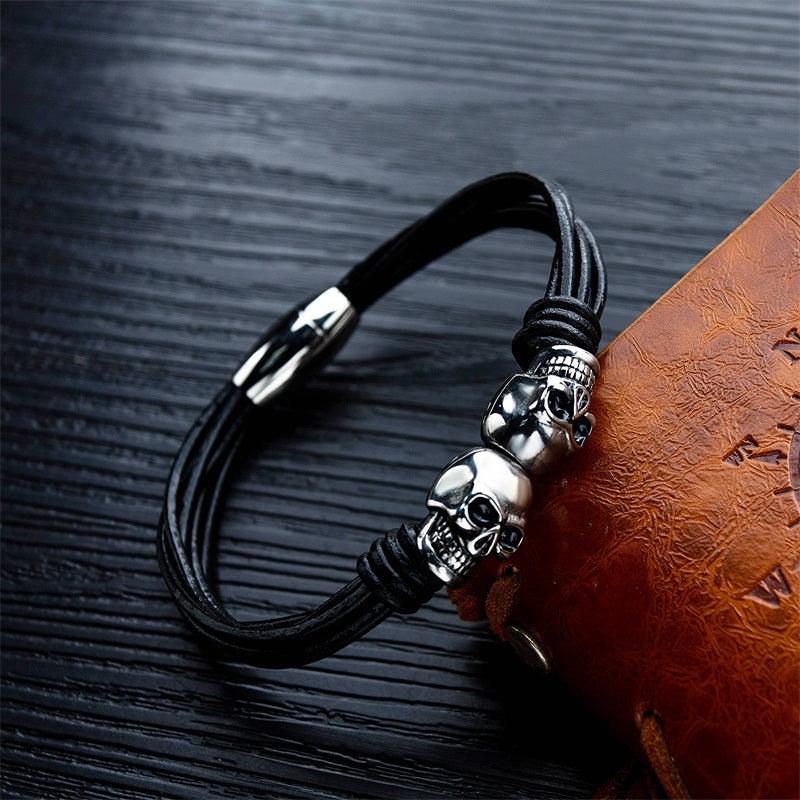 Vintage black double skull bracelet for men and women, stylish unisex stainless steel bangle jewelry.