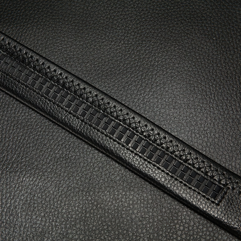 Close-up of vintage black genuine leather belt featuring intricate woven detailing and a sleek finish.