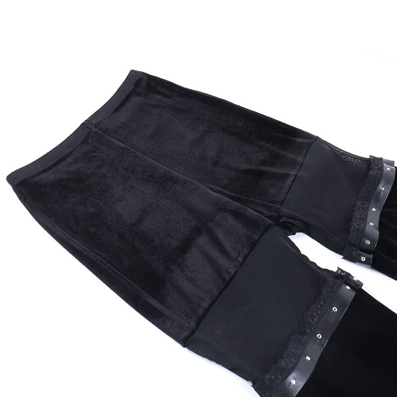 Vintage black velvet flare pants with stylish mesh inserts, perfect for a gothic fashion statement.