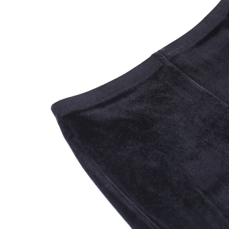Close-up of vintage black velvet fabric showcasing the smooth texture of gothic flare pants.