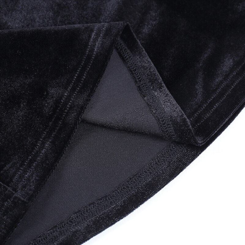 Close-up of black velvet fabric showcasing soft texture and mesh insert of vintage gothic flare pants.