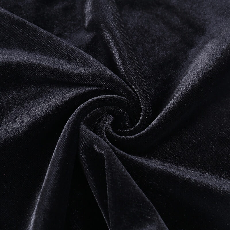 Close-up of luxurious black velvet fabric, showcasing its soft texture and rich depth for vintage flare pants.