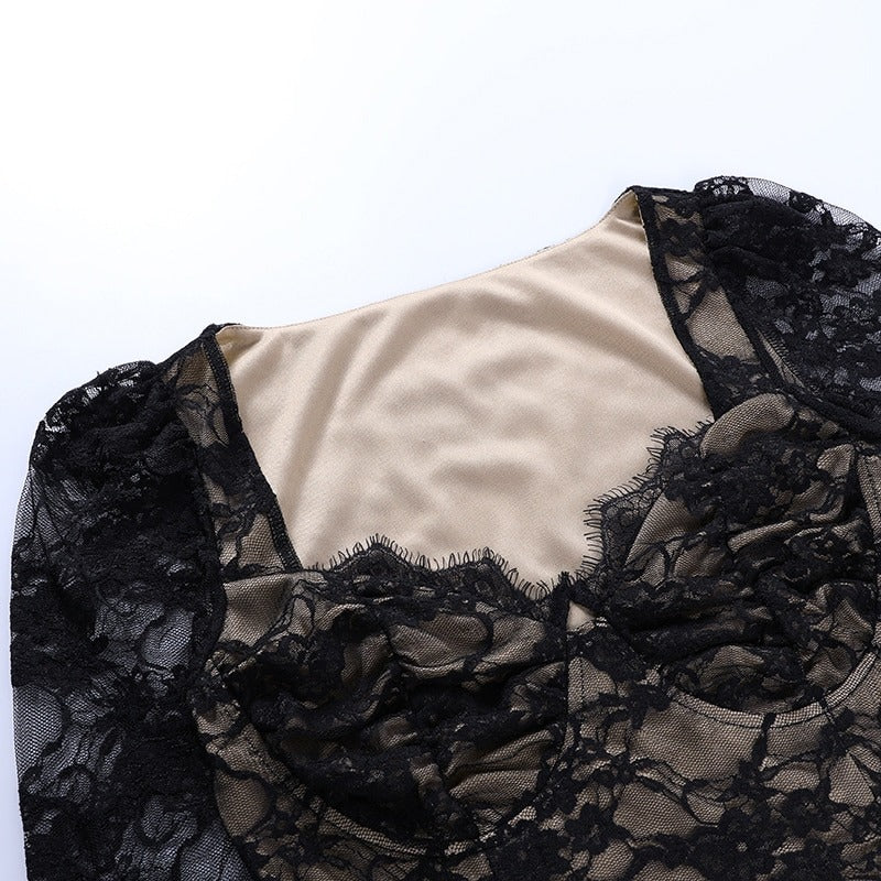 Close-up of vintage black lace women's top showcasing intricate lace design and silky interior for goth style outfit.