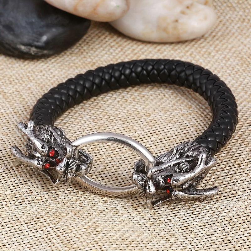 Vintage unisex bracelet featuring metal dragon heads and braided leather, perfect for gothic jewelry enthusiasts.