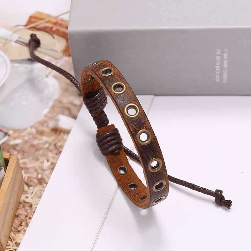Vintage brown leather bracelet with silver circles, adjustable unisex bangle for men and women, showcasing stylish design.