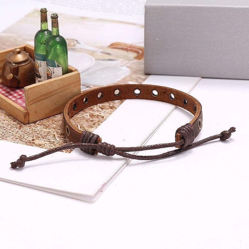 Vintage brown leather bracelet with silver circles, adjustable design for stylish men and women.
